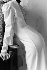 Graceful wedding dress on a thin beautiful figure of the bride Bend in the back