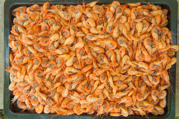 boiled shrimp on a baking sheet as a background