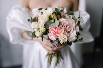 bride holding bouquet of roses