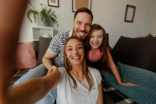 Happy family is having fun in living room. Family enjoying being together. - Powered by Adobe
