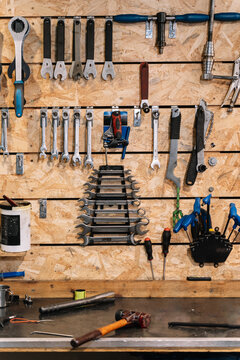 Assorted tools hanging on wall in workshop