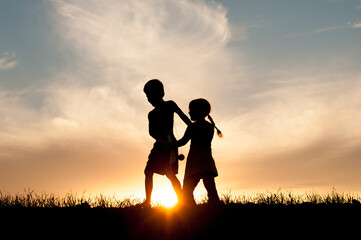 Fototapeta na wymiar Kids Playing Together in Silhouette 