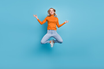 Obraz premium Full body photo of cheerful young positive woman jump up asana om signs isolated on blue color background
