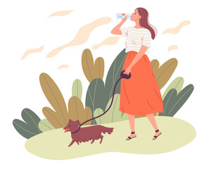 Young woman walking her dog and drinking water