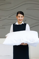 Room service maid cleaning and making bed hotel room concept, portrait of young beautiful Asian...