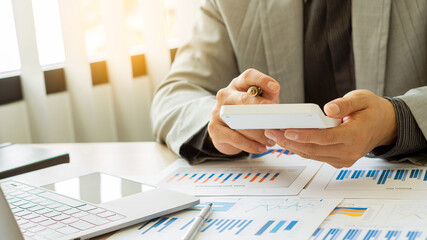 Businessman looking at the company's financial graph document for analysis and guidance. Asian...