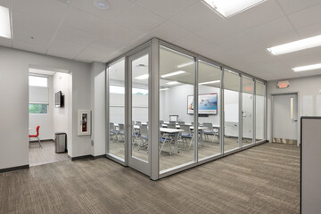 Corridor in office business school building with classroom conference room with desks and chairs
