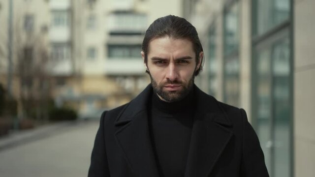 Serious man walking down the street