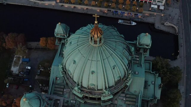 Aerial view from ascending drone on Berlin Cathedral roof. Large green dome and four turrets in corners of church. Berlin, Germany.