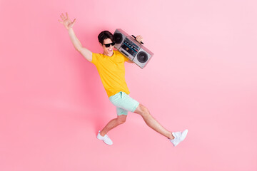Fototapeta na wymiar Top above high angle full body photo of young guy happy smile hold boom box go isolated over pink color background
