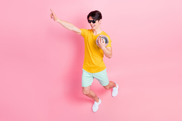 Photo of crazy cool positive guy dance beach party hold glitter ball wear yellow t-shirt shorts...
