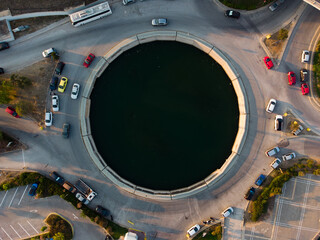 Aerial top down view of a circular lake - crossroad