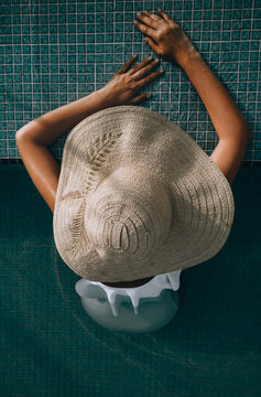 Woman With A Hat By The Pool 