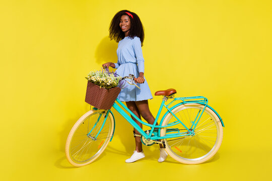 Full body photo of happy afro american woman bike spring good mood smile isolated on yellow color background