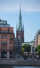 The tower of the church Klara kyrka behind business buildings in Stockholm