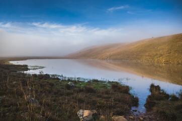 Beautiful lake landscape in a foggy day