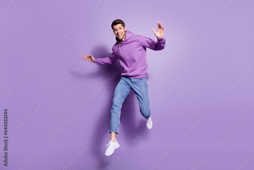 Poster full length body size photo man jumping up cheerful overjoyed isolated pastel purple color backgroun