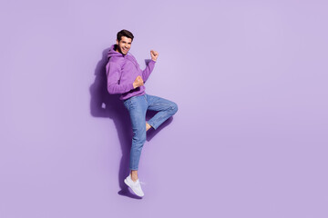 Fototapeta na wymiar Full length body size view of attractive lucky cheerful guy jumping rejoicing great news isolated over purple violet color background