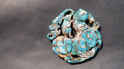 Turquoise jade pendant carved with 4 animals (horse, monkey, bird, dragon) diameter 6.8 cm thick...