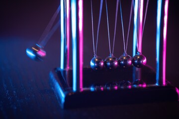 Newton cradle. Demonstrating gravity, action and reaction principle. - obrazy, fototapety, plakaty