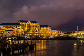 Fototapeta premium Victoria and Alfred Waterfront, harbor with recreation boats, shops and restaurants in the evening. Cape town, South Africa.