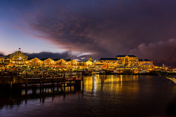 Victoria and Alfred Waterfront, harbor with recreation boats, shops and restaurants in the evening....