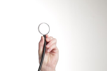 Hand holding stethoscope isolated on white background