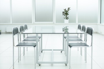 Laptop on glass table in spacious office space