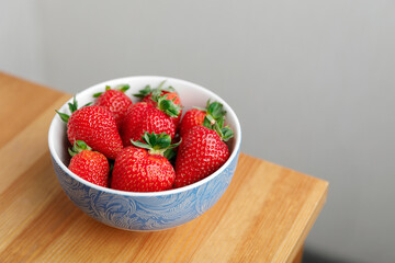 plate with strawberries on a wooden table