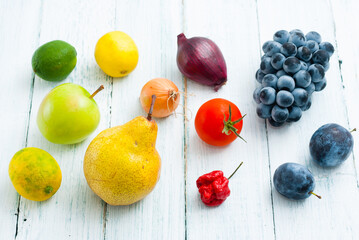 Naklejka na ściany i meble fruits and vegetables on white wooden table