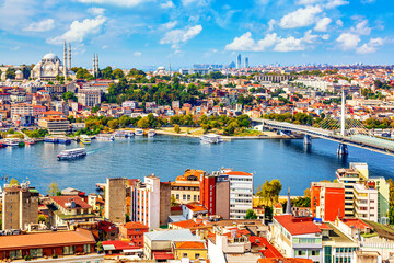 Touristic sightseeing ships in Golden Horn bay of Istanbul and mosque with Sultanahmet district against blue sky and clouds. Istanbul, Turkey during sunny summer day.