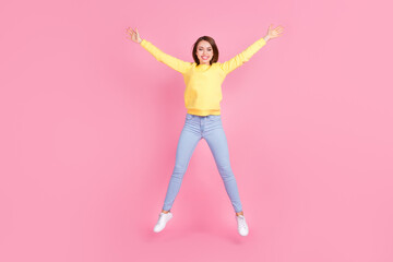 Fototapeta na wymiar Full length body size photo girl careless playful jumping up smiling isolated pastel pink color background