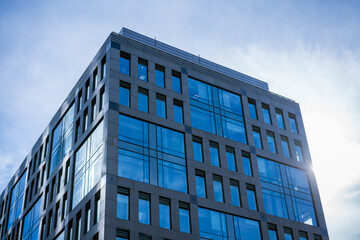 Glass facades of office buildings against a blue sky