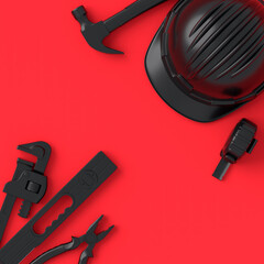 Top view of monochrome construction tools for repair on red and black