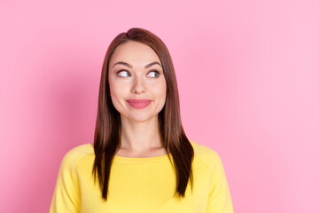 Fototapeta premium Portrait of attractive dreamy curious cheery girl guessing thinking copy space isolated over pastel pink color background
