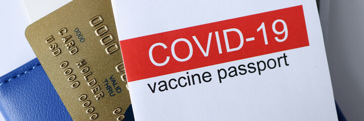 Closeup of covid 19 vaccination passport and credit bank card