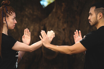 couple practicing kung fu in the park