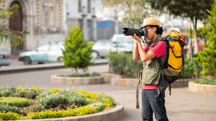 Man taking photos with his professional camera in the plaza of Salcajá, Guatemala.