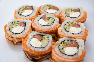 Japanese cuisine. Rolls in plates on a concrete background. with salmon,
