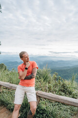 Yong man watching Sunset in the Mountains at Doi Pui Viewpoint Doi Suthep-Pui National Park