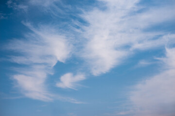 Scattered cloud clusters in a blue sky, blue sky background with white clouds,