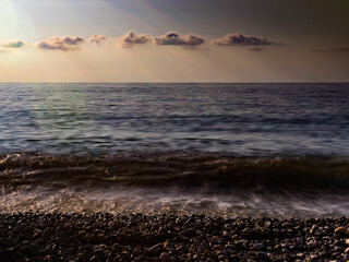 Obraz premium calm dramatic photo of the sea shore with pebbles. photo on film