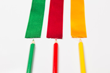 Coloured pencils wrapped in a green ribbon