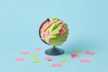 Colored adhesive paper stickers on globe