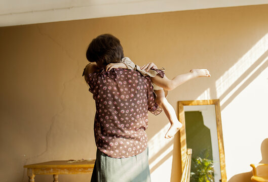 Mother playing with daughter in retro room