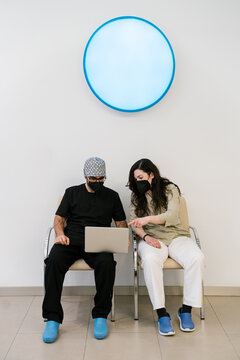 Doctors using the laptop computer while sitting in the hospital