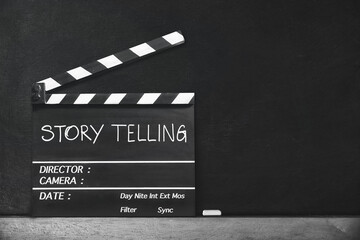 Storytelling concept.Handwriting on film slate.Black and white photography, classic Cinema, retro style.