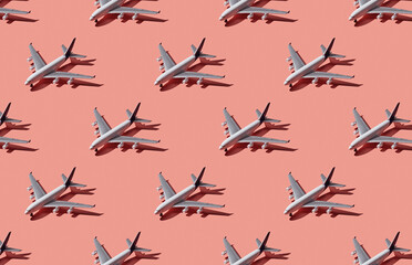 Pattern of plane models on pink pastel background