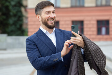successful businessman takes photos on a mobile phone