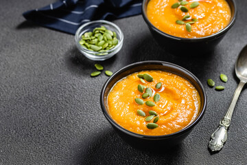 Curried pumpkin soup on dark background.Space for text.
